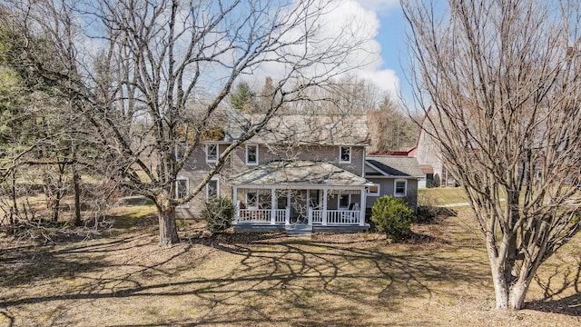 rear view of property with a porch