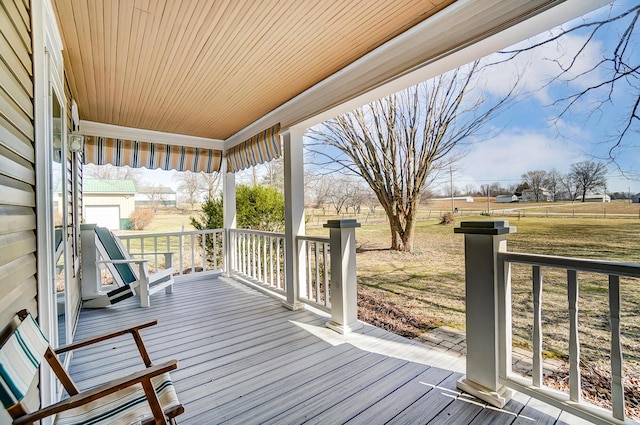 wooden deck featuring a lawn