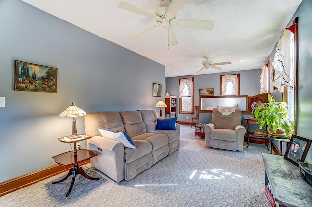 living room featuring baseboards and a ceiling fan