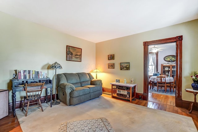 living area with baseboards and hardwood / wood-style floors