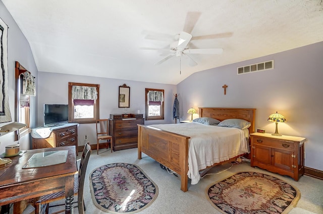 bedroom featuring visible vents, a ceiling fan, baseboards, lofted ceiling, and light colored carpet