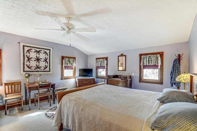 bedroom with ceiling fan, a textured ceiling, lofted ceiling, and carpet