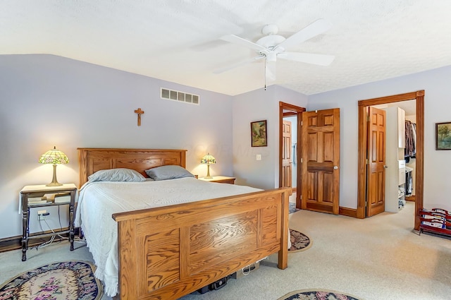 bedroom with baseboards, light colored carpet, visible vents, and ceiling fan