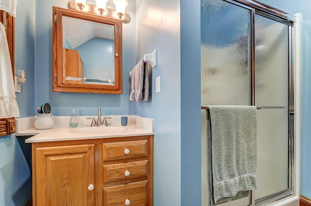 full bath with vanity and a shower stall