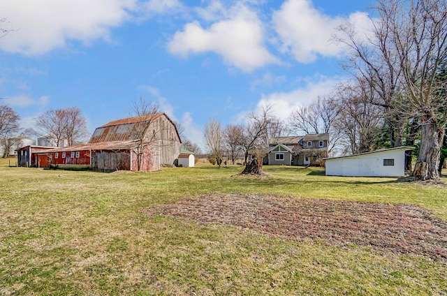 view of yard featuring a barn and an outbuilding