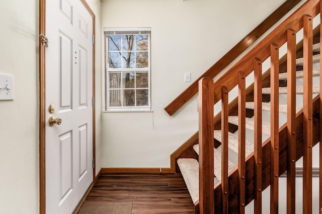 stairs featuring wood finished floors and baseboards