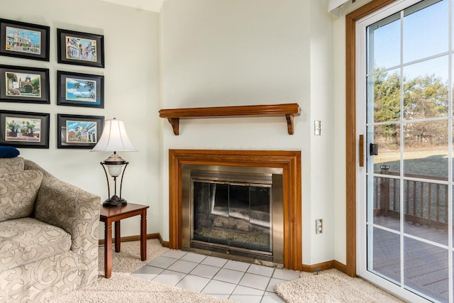 interior space with a fireplace with flush hearth and baseboards