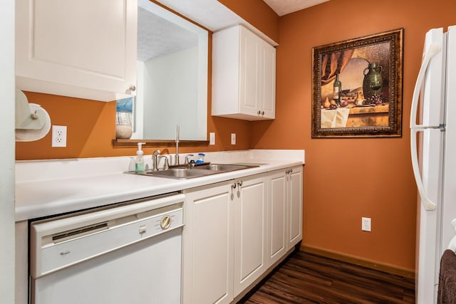 kitchen featuring a sink, dark wood-style floors, white cabinetry, white appliances, and light countertops