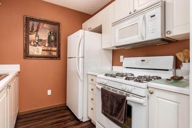 kitchen featuring white appliances, white cabinets, and light countertops