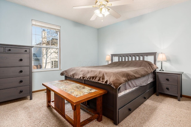 bedroom with baseboards, light carpet, and a ceiling fan