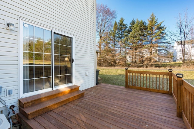 wooden terrace with a lawn