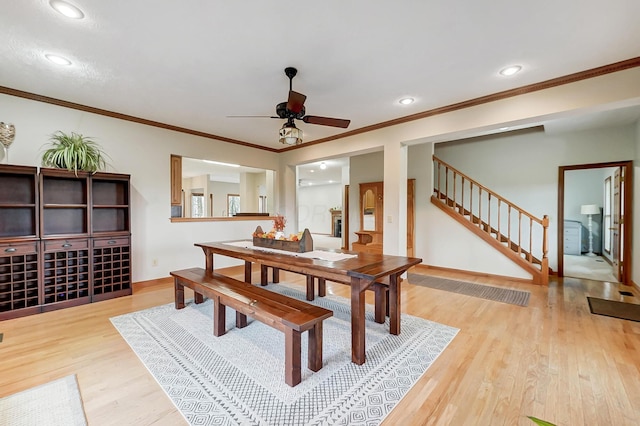 dining space with recessed lighting, stairway, baseboards, and wood finished floors