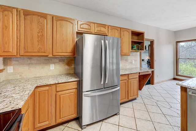 kitchen with light stone counters, light tile patterned floors, open shelves, stainless steel appliances, and backsplash