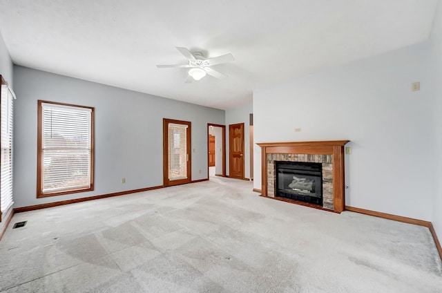 unfurnished living room with carpet flooring, a fireplace, and baseboards