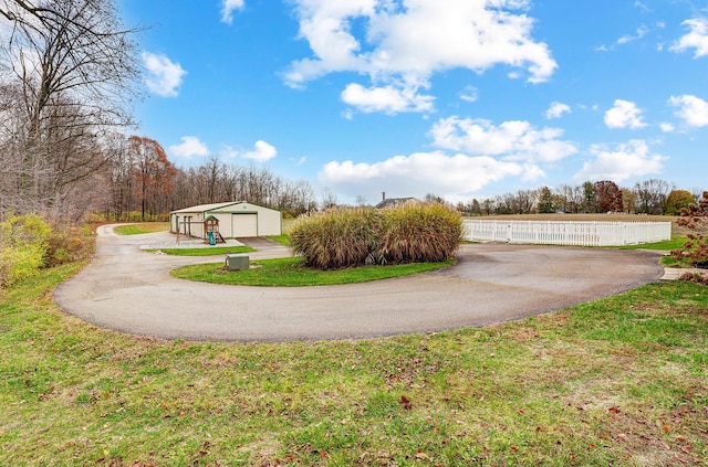 view of yard with a garage and an outdoor structure