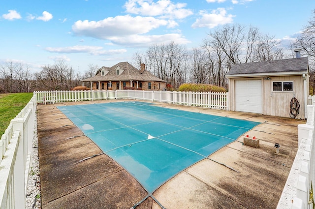 view of pool featuring a fenced in pool, an outbuilding, a patio area, and fence