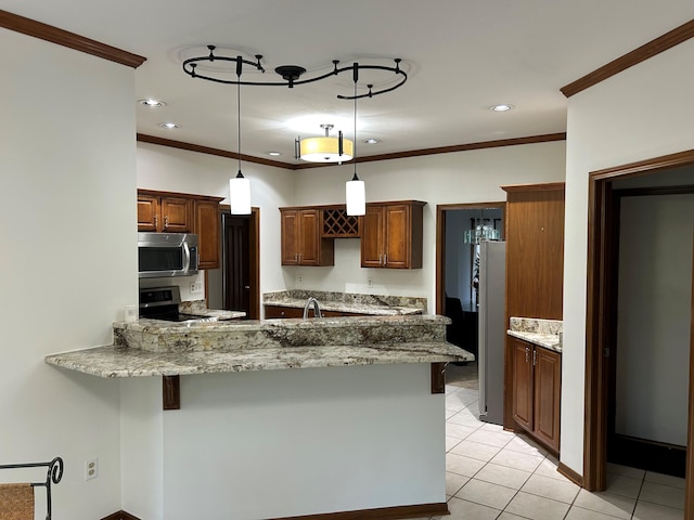 kitchen featuring crown molding, light tile patterned flooring, appliances with stainless steel finishes, a peninsula, and pendant lighting