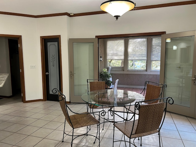 dining room with crown molding, light tile patterned flooring, and baseboards