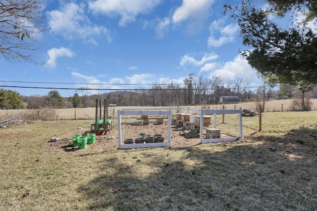 view of yard featuring fence and a garden