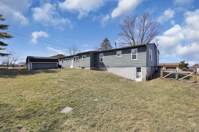 rear view of property with a gate, a yard, and fence