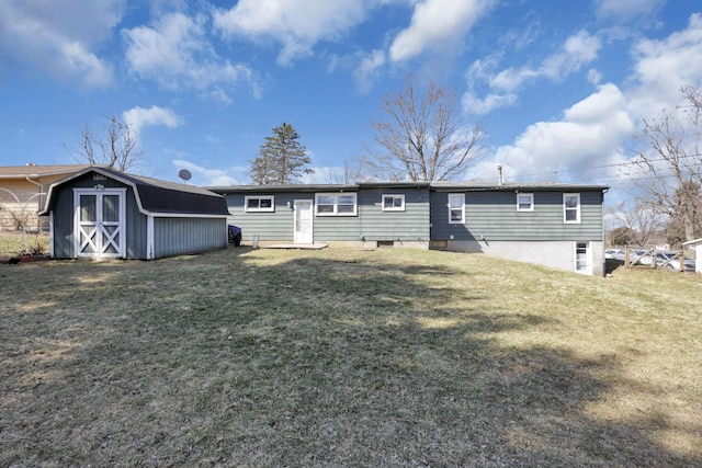 back of property with an outdoor structure, a yard, and a shed