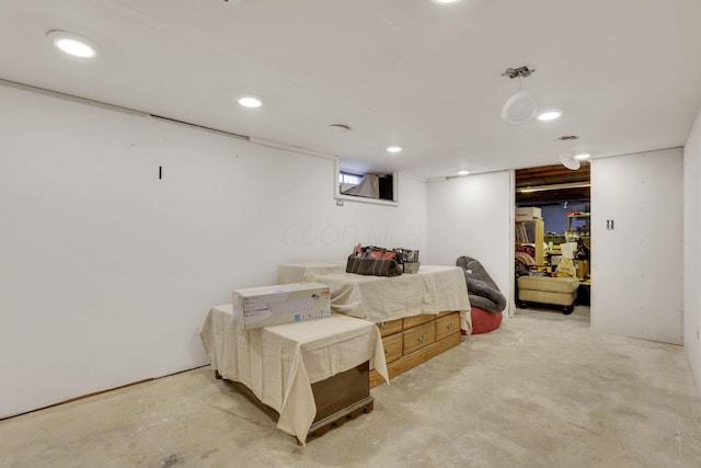 bedroom with recessed lighting and concrete flooring