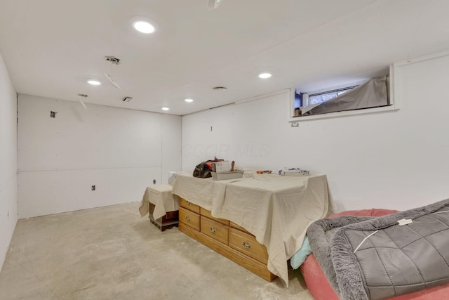 bedroom featuring recessed lighting and concrete flooring