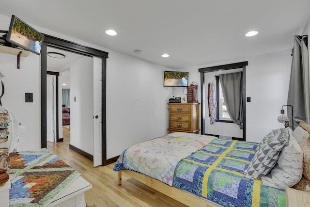 bedroom with recessed lighting, light wood-type flooring, and baseboards