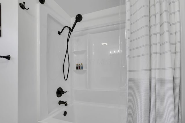 bathroom with shower / bath combo with shower curtain