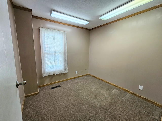 spare room with baseboards, carpet, visible vents, and a textured ceiling