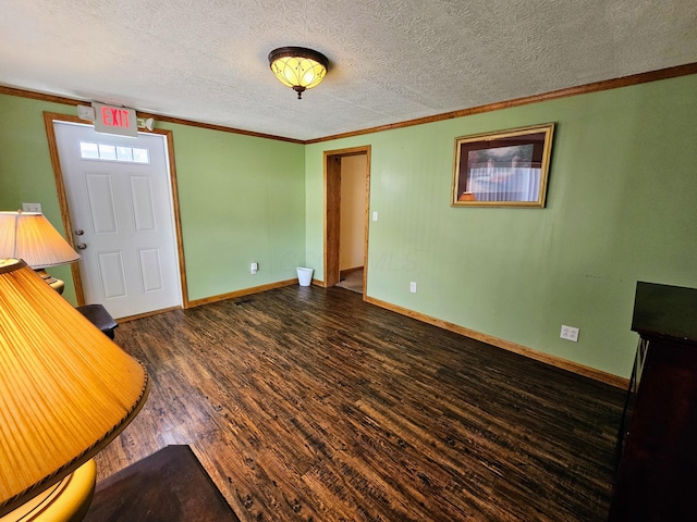 interior space featuring crown molding, dark wood-style floors, baseboards, and a textured ceiling