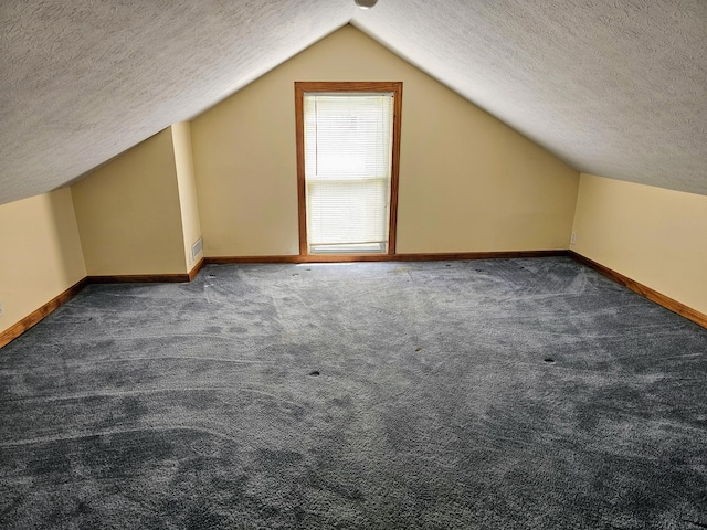 bonus room featuring carpet flooring, baseboards, and a textured ceiling