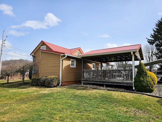 view of home's exterior with a lawn and metal roof