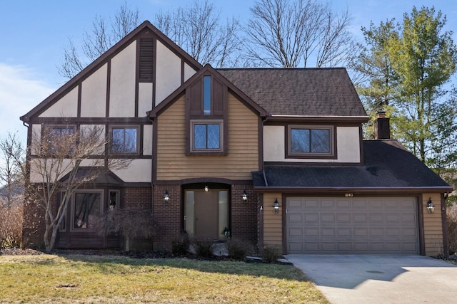 view of front of house with a front yard, driveway, a shingled roof, stucco siding, and brick siding