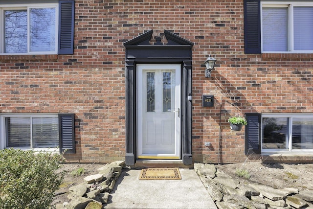 entrance to property with brick siding