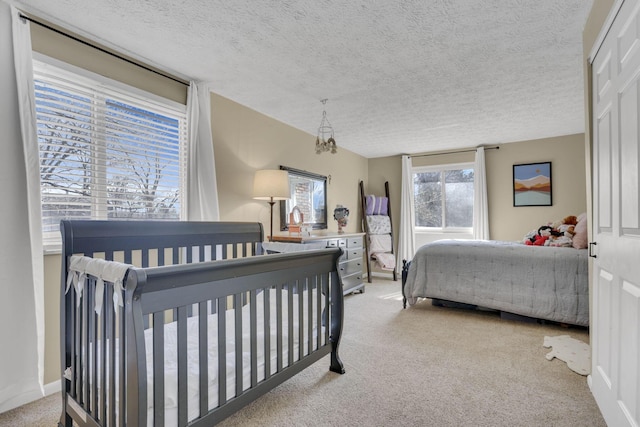 bedroom with a textured ceiling and carpet flooring