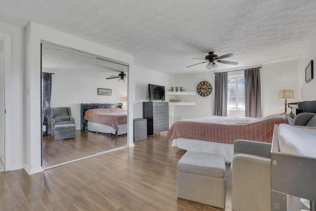 bedroom featuring a textured ceiling, ceiling fan, and wood finished floors