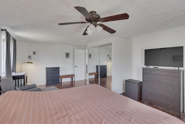 unfurnished bedroom with a ceiling fan, wood finished floors, baseboards, and a textured ceiling