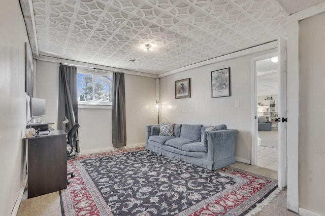 living area featuring baseboards and an ornate ceiling