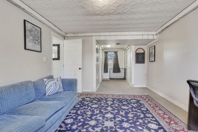 living area featuring carpet flooring, an ornate ceiling, and baseboards