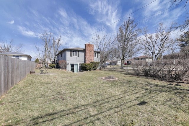 view of yard with a fire pit and a fenced backyard