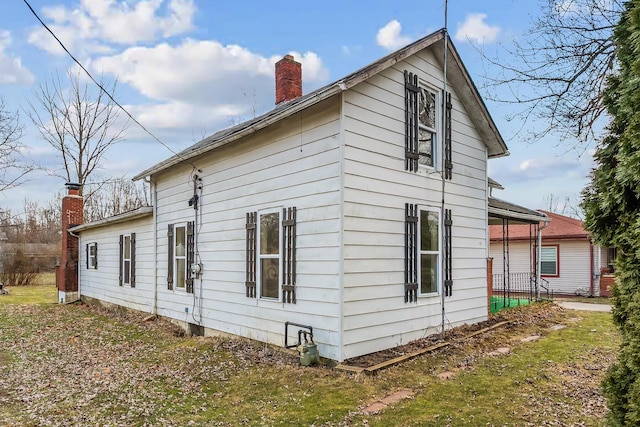 view of side of property with a chimney