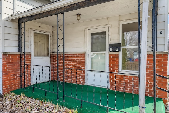 property entrance featuring brick siding