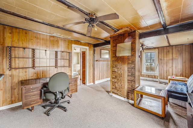 office area with a ceiling fan, carpet, baseboards, and wood walls