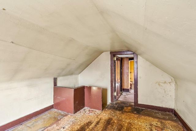 additional living space featuring lofted ceiling