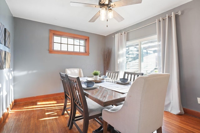 dining space featuring hardwood / wood-style floors, plenty of natural light, baseboards, and ceiling fan