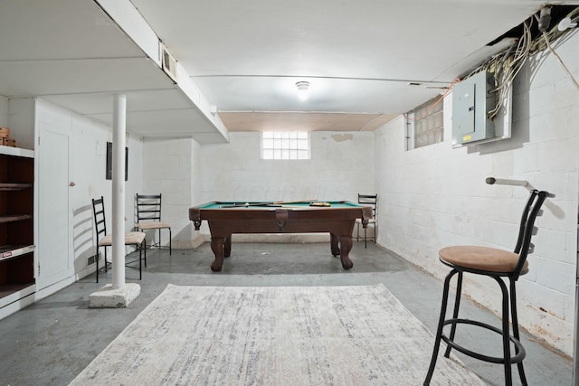 playroom featuring electric panel, concrete block wall, concrete floors, and pool table