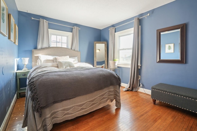 bedroom featuring hardwood / wood-style floors and baseboards