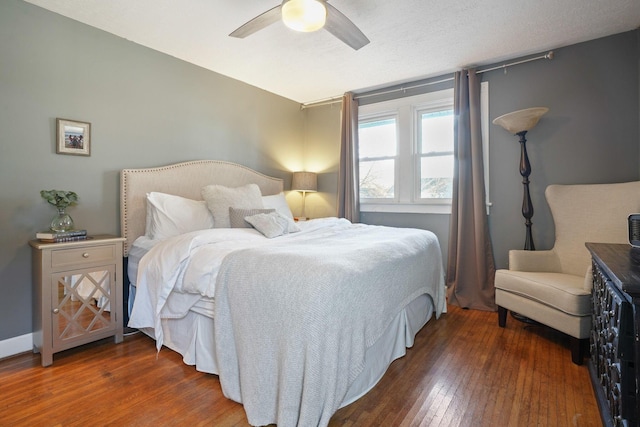 bedroom with baseboards, wood-type flooring, and a ceiling fan