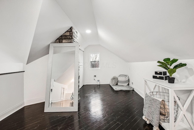 bonus room with baseboards, lofted ceiling, and wood finished floors